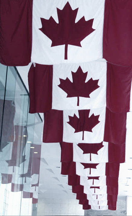Series of Canada flags hanging inside commercial building in Ontario
