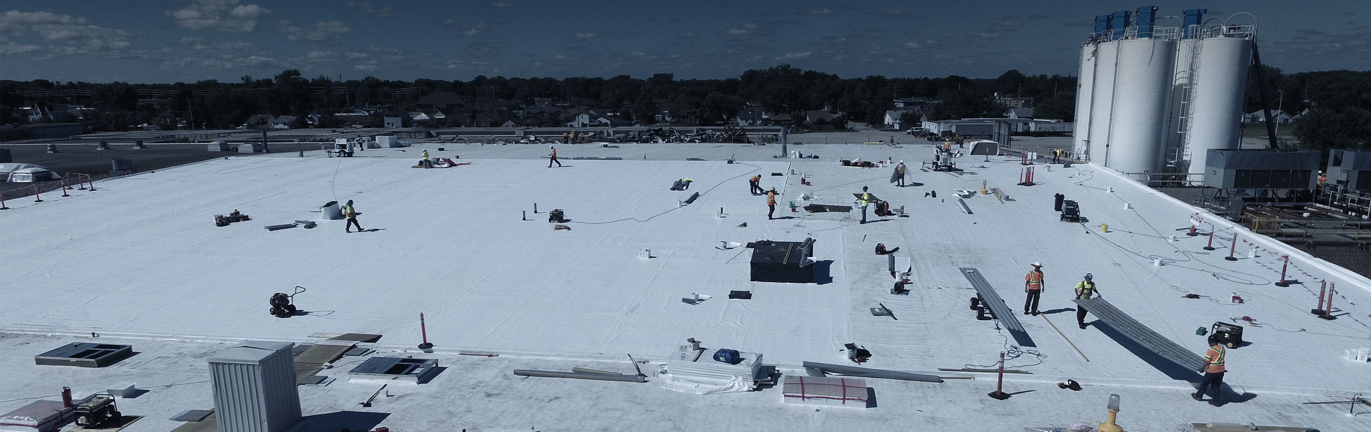 Overhead view of Empire Roofing employees working on commercial flat roof installation/repair